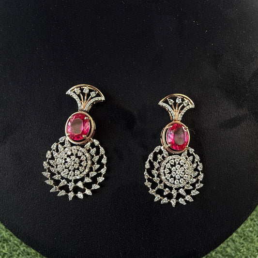 gold diamond earrings with a floral pattern and red and white diamonds, displayed on a mannequin.