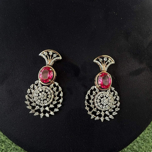 gold diamond earrings with a floral pattern and red and white diamonds, displayed on a mannequin.