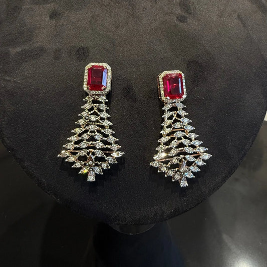 Color stone and diamond earrings is displayed on a mannequin.