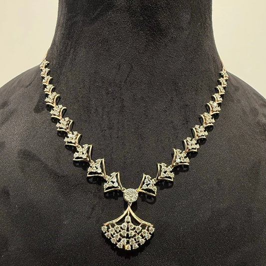 A luxurious gold diamond necklace with earrings set, displayed on a mannequin bust.