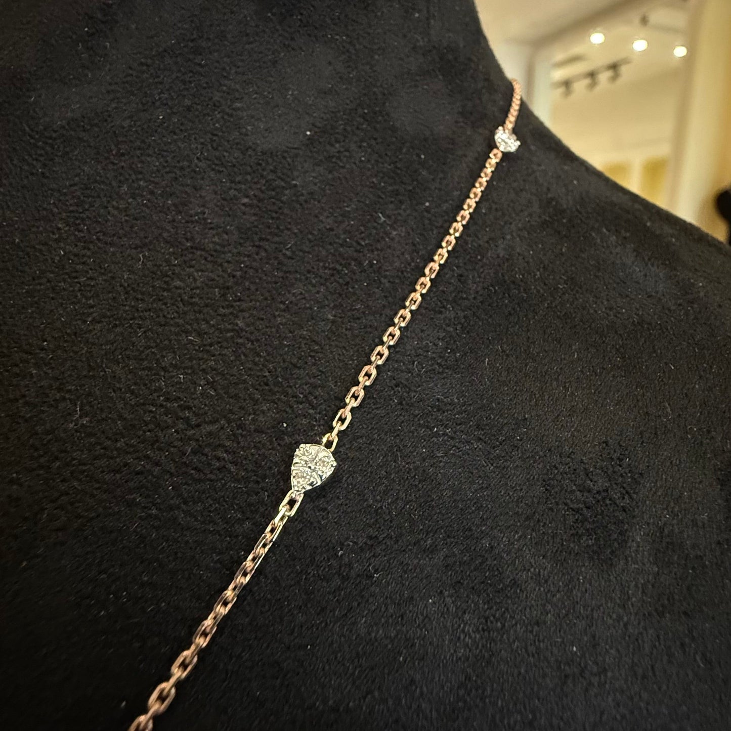 Modern diamond chain necklace set with hexagon pendant on display.