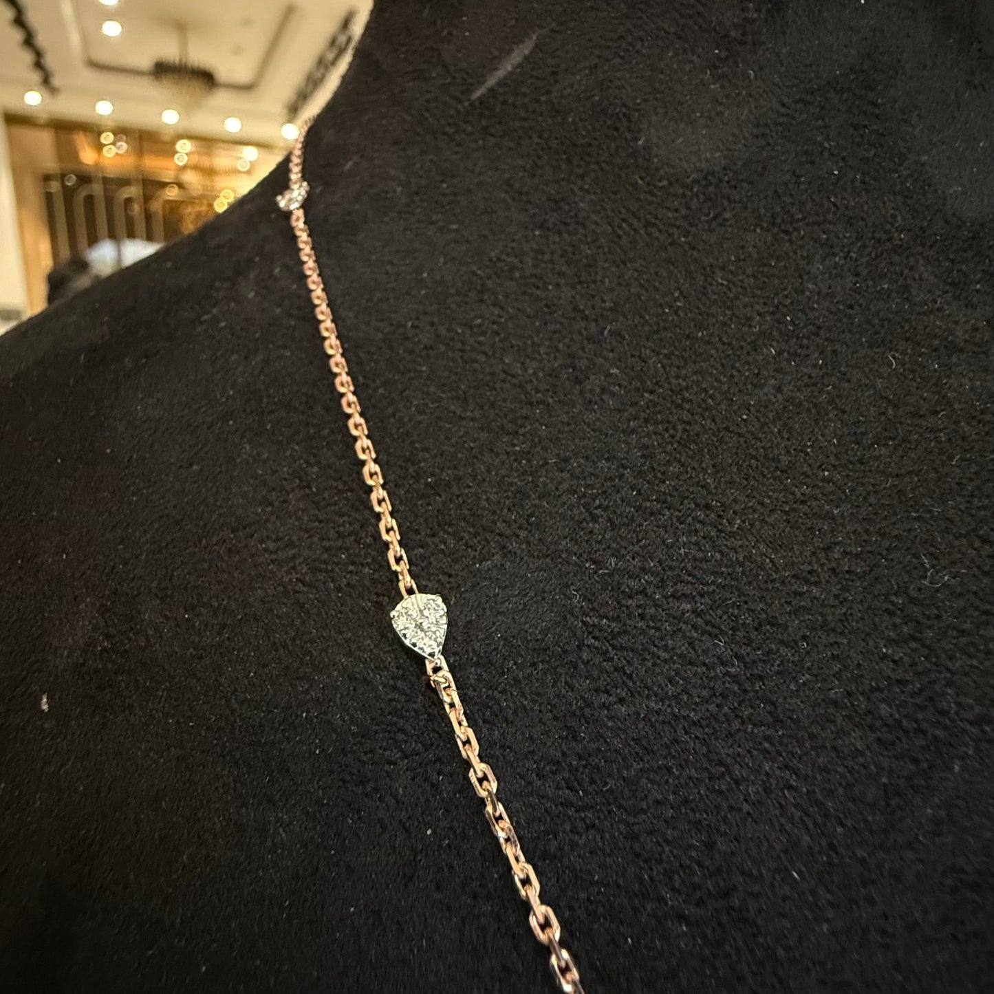 Modern diamond chain necklace set with hexagon pendant on display.
