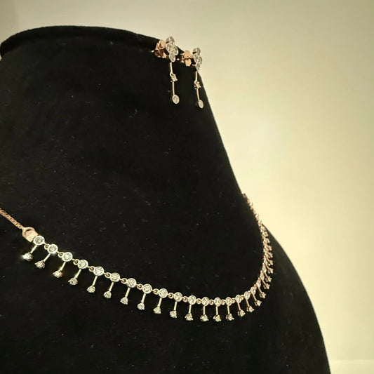 A mannequin showcasing a minimalist diamond necklace and earrings set in gold.