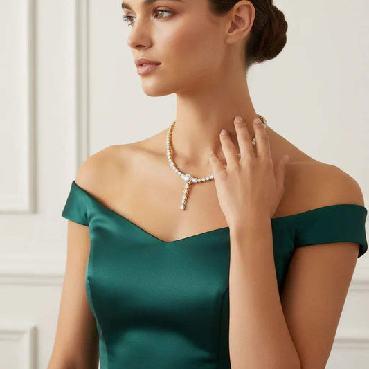 Woman wearing a green dress and real diamonds necklace against a neutral background