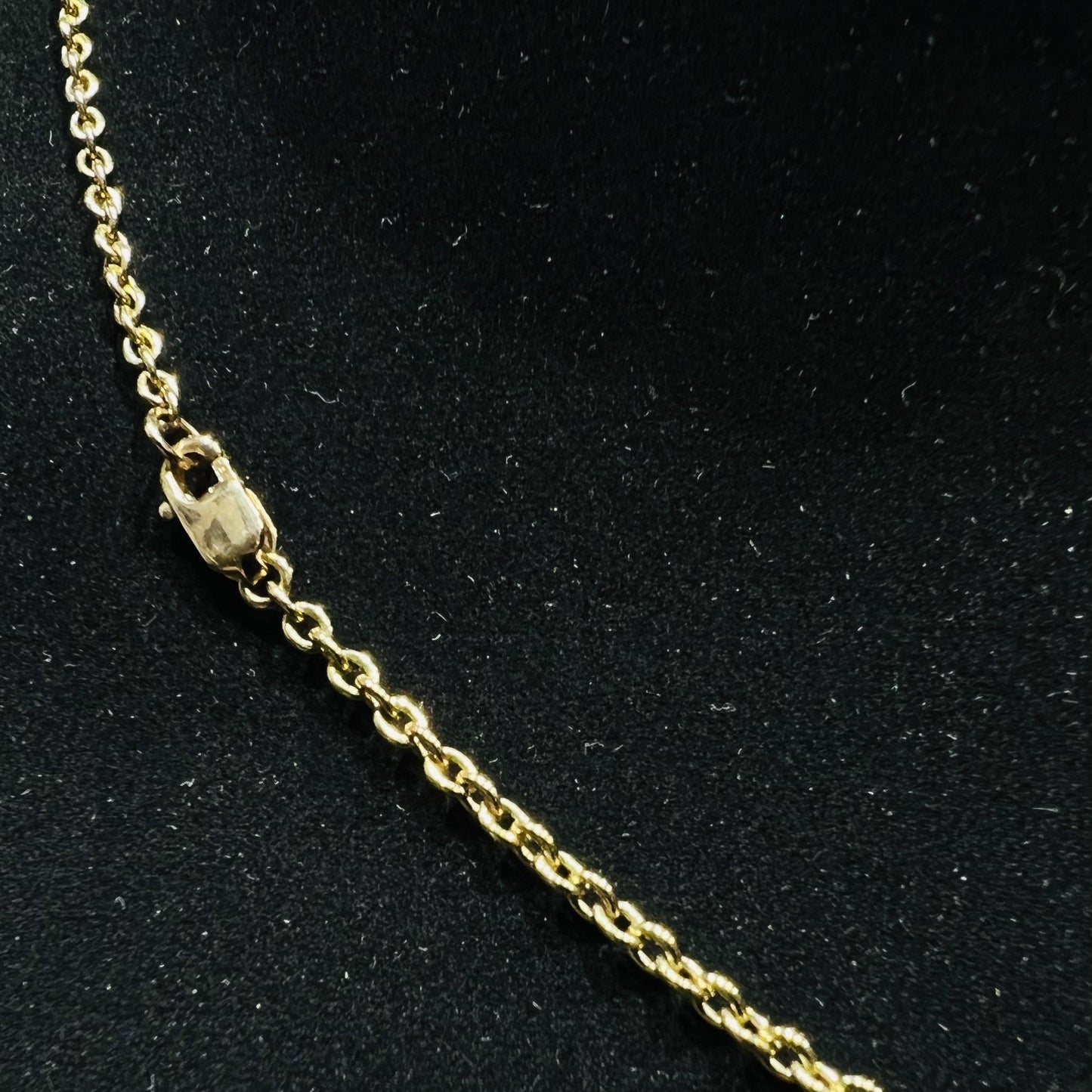 A stylish gold diamond beaded mangalsutra with seven round bezel-set diamonds in a row, paired with small black beads on a delicate gold chain.