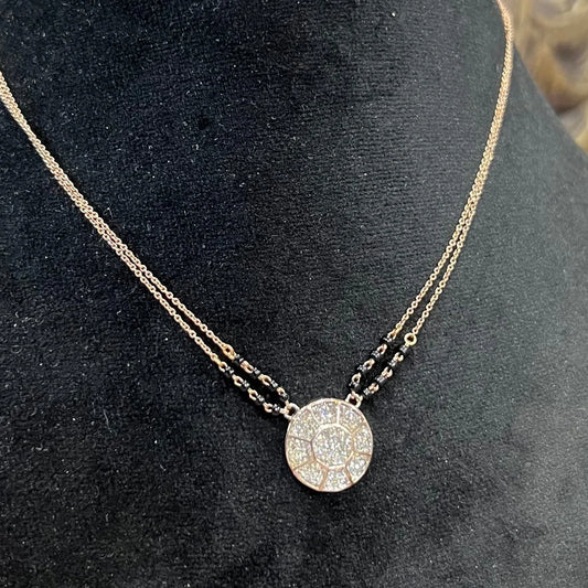 Elegant gold diamond mangalsutra with a circular diamond-studded pendant in honeycomb design, paired with black bead and gold chain for a modern traditional look.