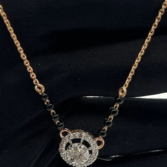 Elegant gold diamond mangalsutra with round halo diamond pendant and dual black bead gold chain, perfect for daily wear and modern bridal style.