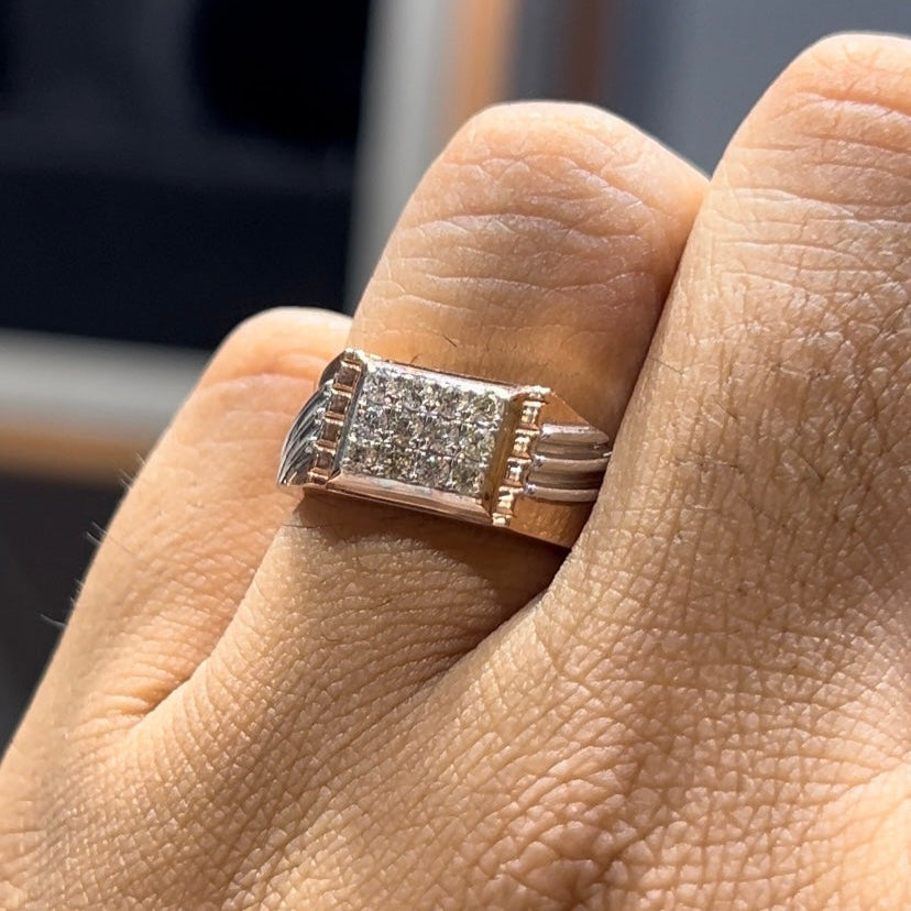A man's hand displaying a diamond ring on his finger.