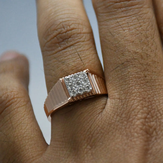 Rose gold ring with diamond accent on a finger against a neutral background