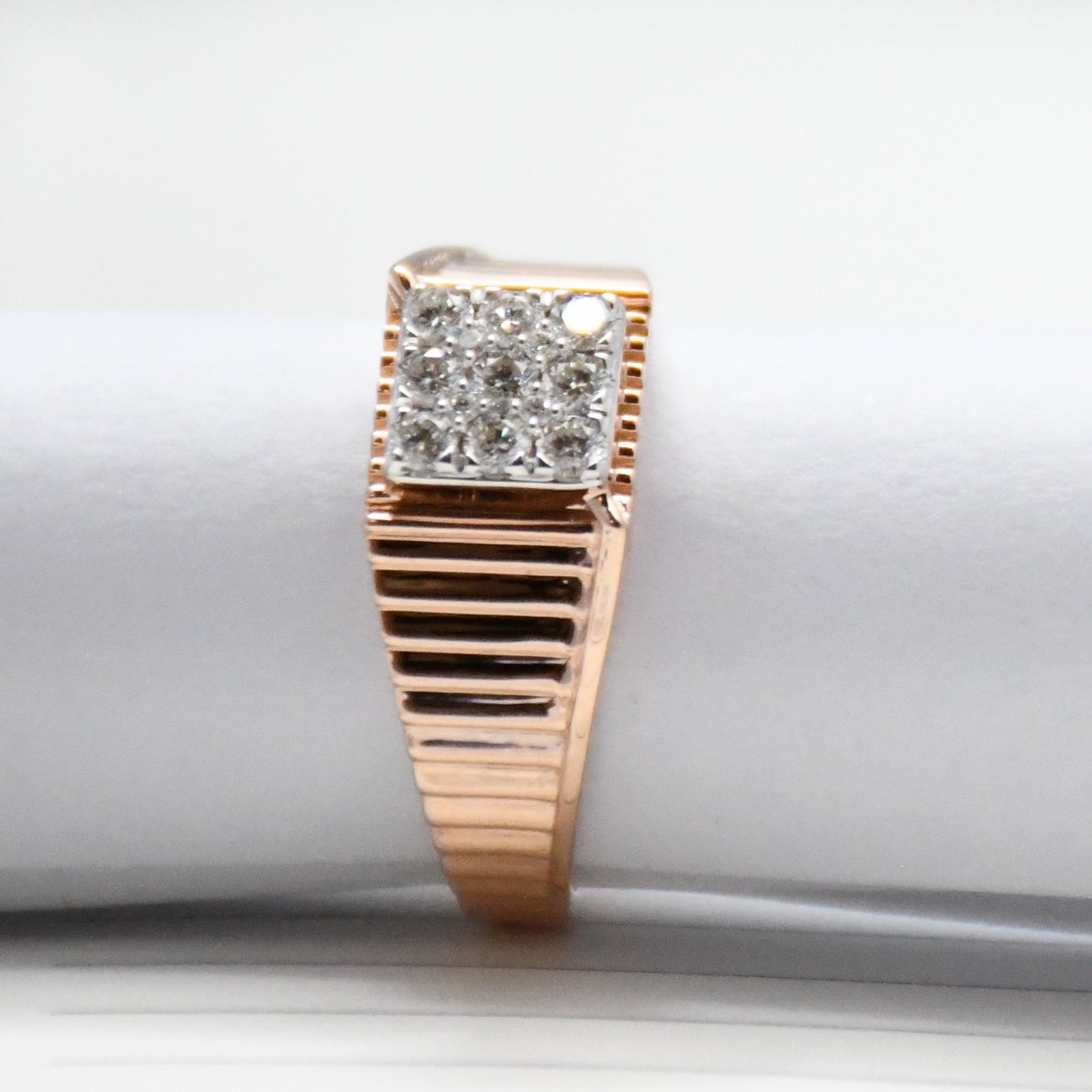gold ring with diamond accents on a white surface