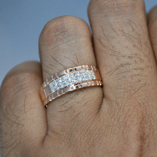 gold ring with diamonds on a person's finger against a gray background