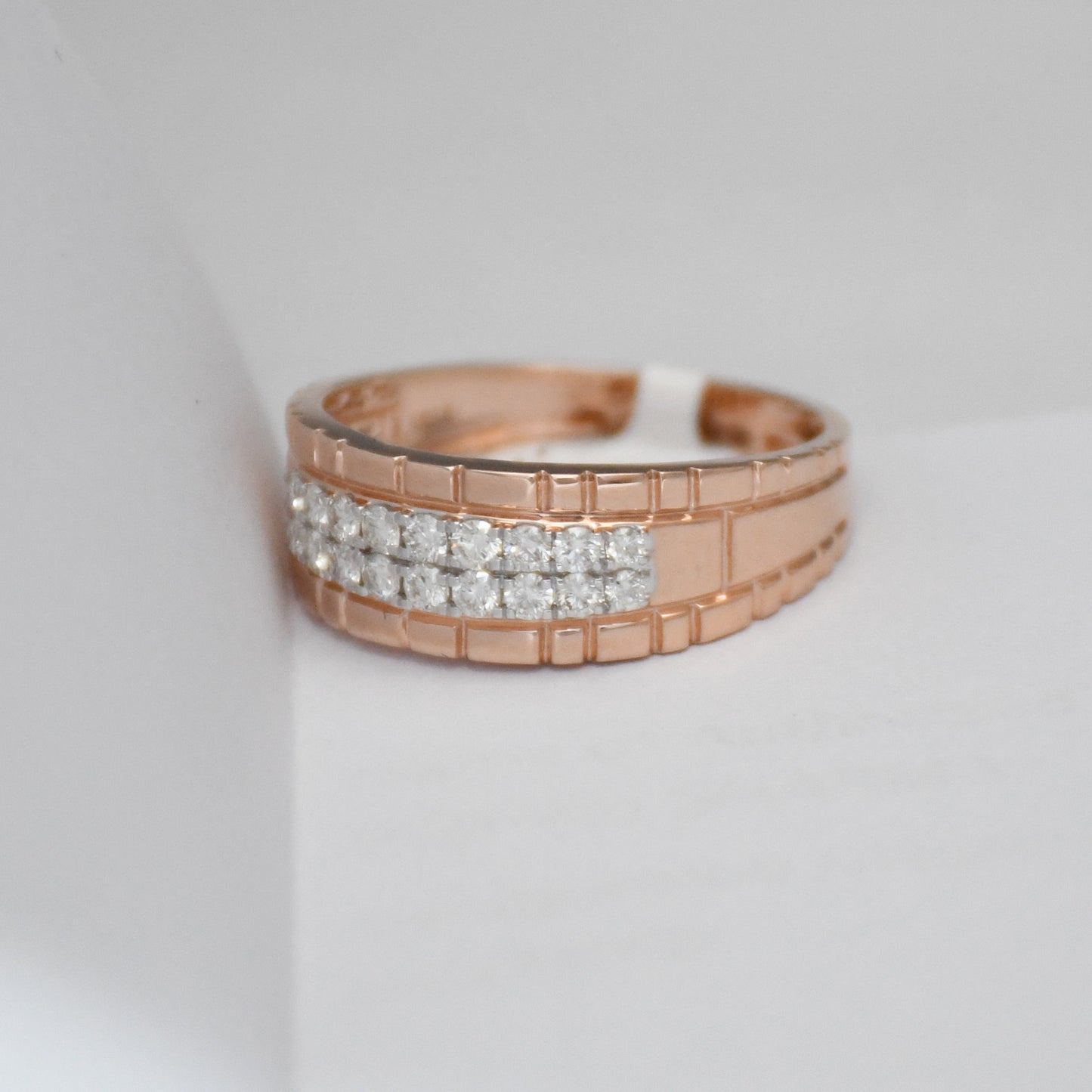 gold ring with diamond accents on a light gray background