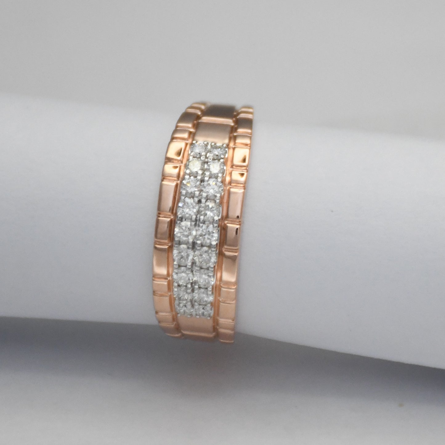 gold ring with embedded diamonds on a gray background