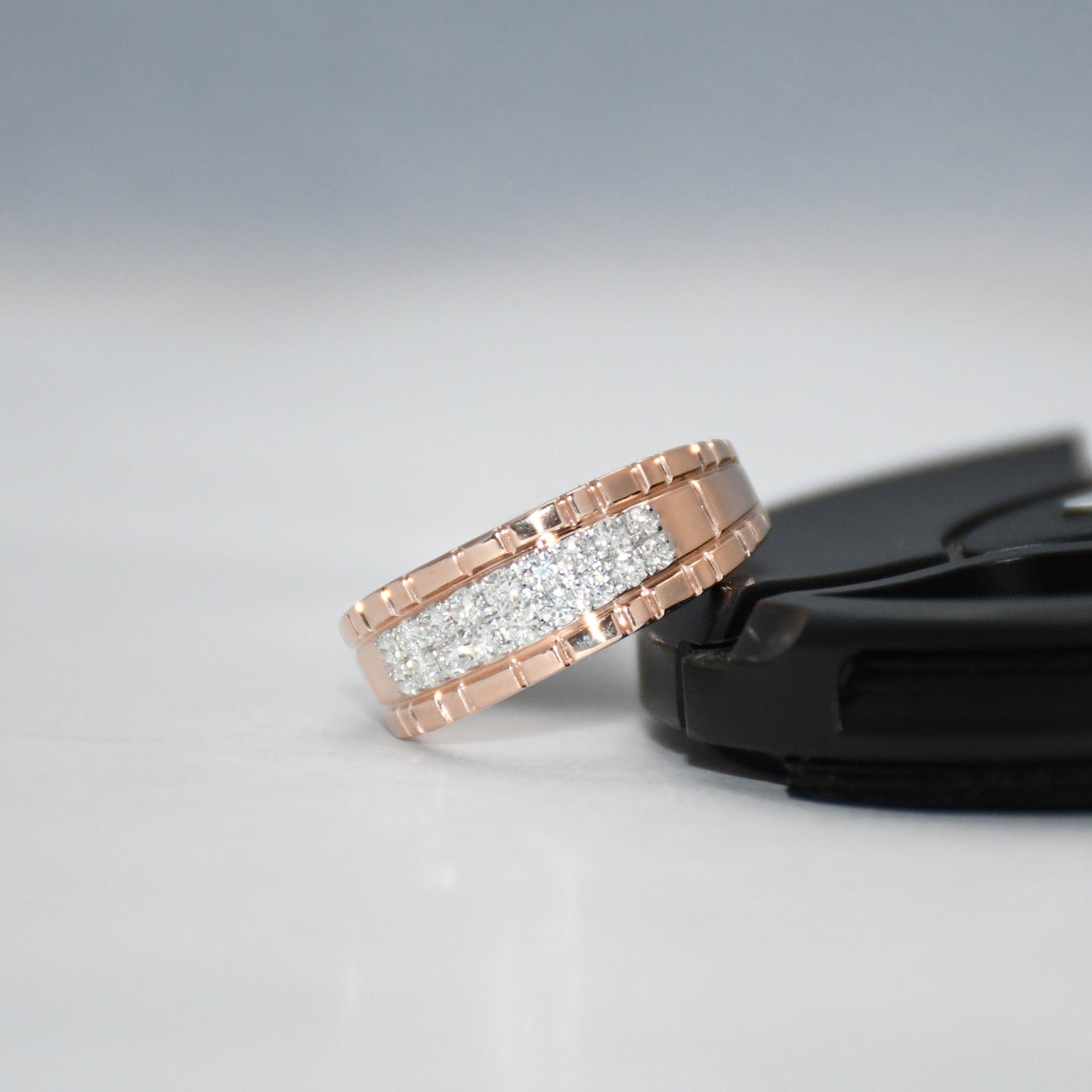 gold ring with diamonds on a gray background