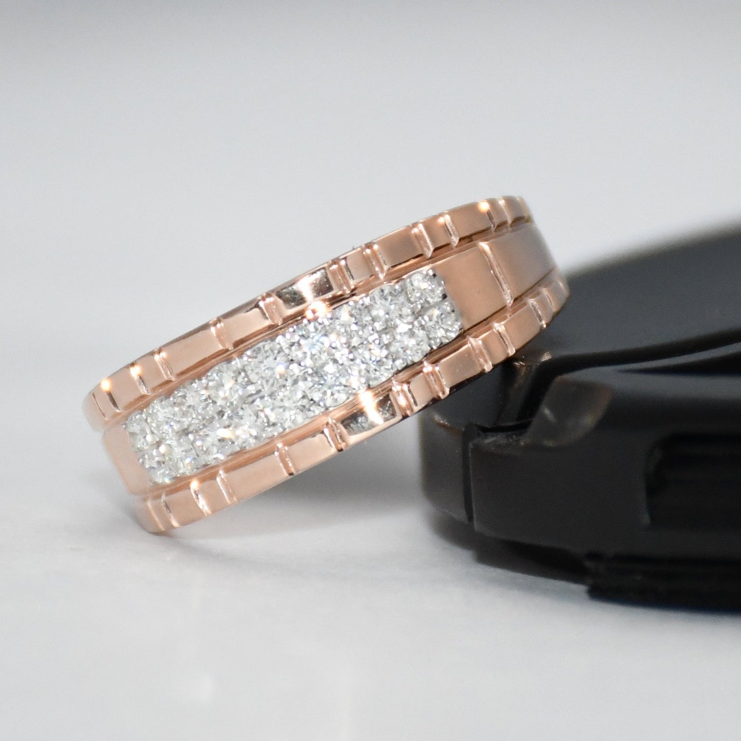 gold ring with diamonds on a gray background