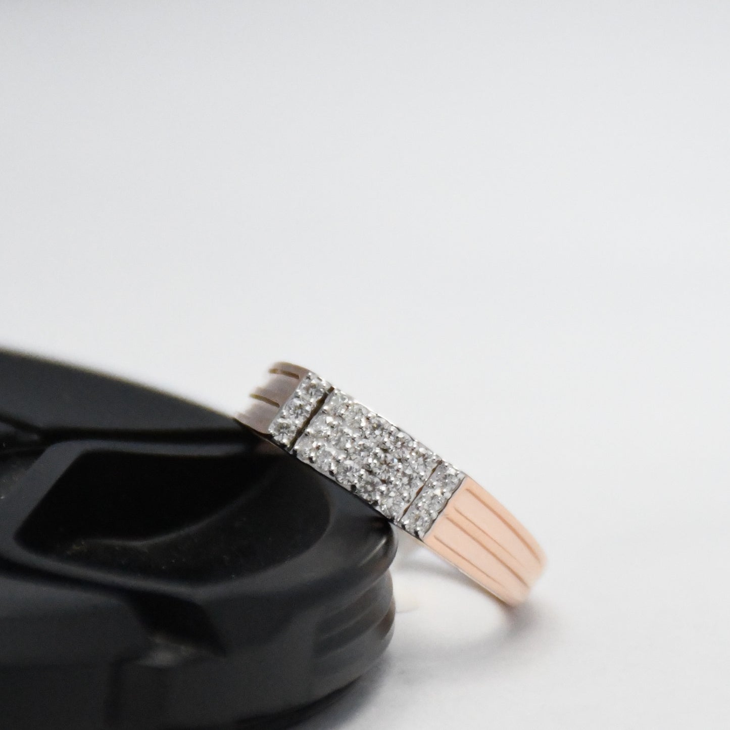 Close-up of a real men's ring with diamonds on a white background
