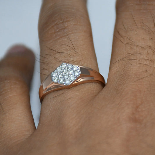 gold ring with a diamond on a person's finger against a white background