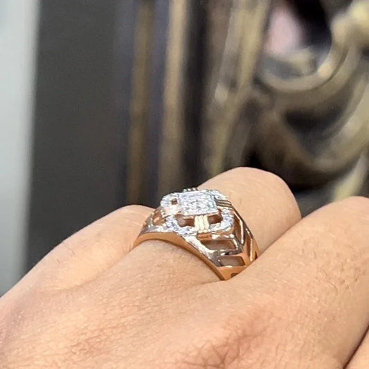 A man's hand displaying a gold band ring with diamonds cluster in the center.
