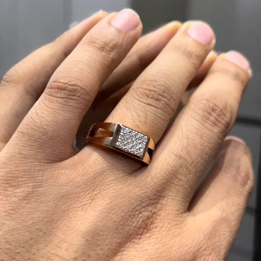 A man's hand displaying a diamond ring with a gold band.