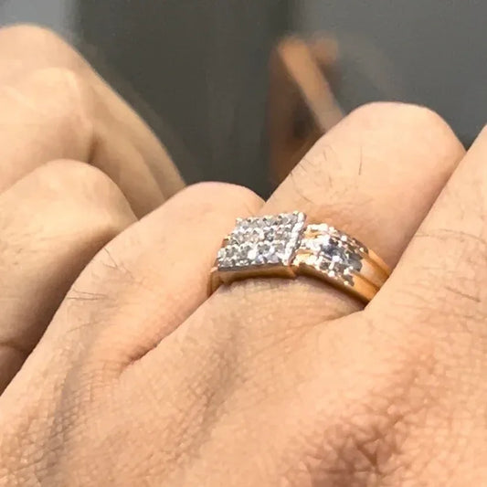 Men’s diamond ring in dual-tone gold with bold rectangular cluster of round diamonds at the center, flanked by sleek metal panels, shown worn on finger.