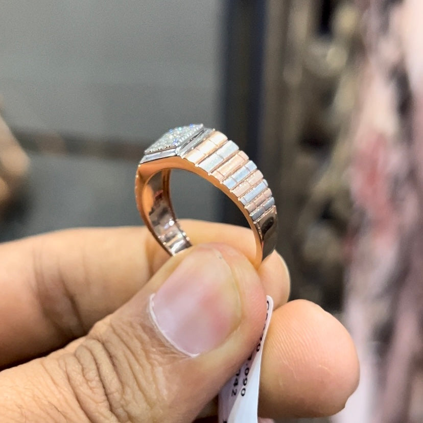 Stylish men’s diamond ring with a geometric square cluster centerpiece and textured rose gold band, shown in hand for scale.