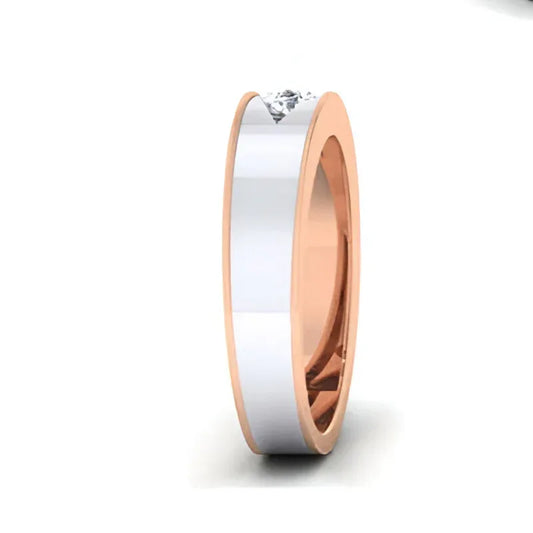 Two-tone ring with a diamond on a white background