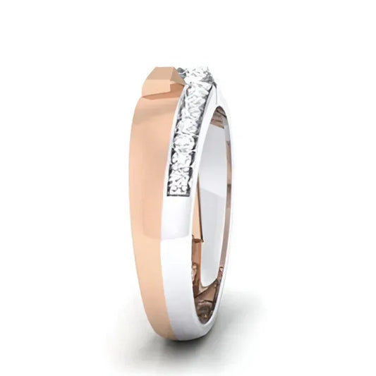 A gold band ring with a row of sparkling diamonds set on one side, with alternating polished and textured finishes.