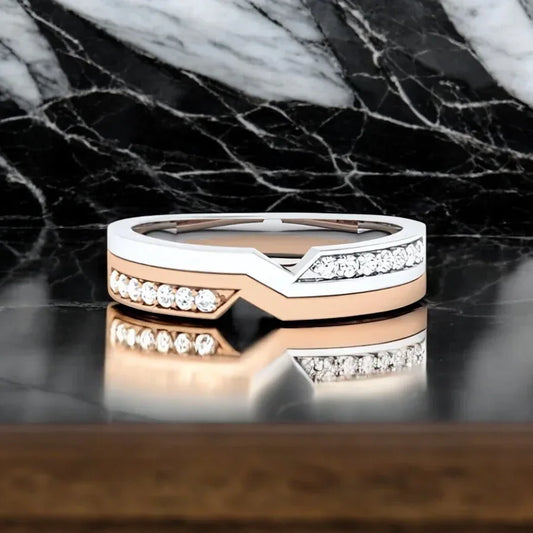 Two-tone ring with diamonds on a marble surface