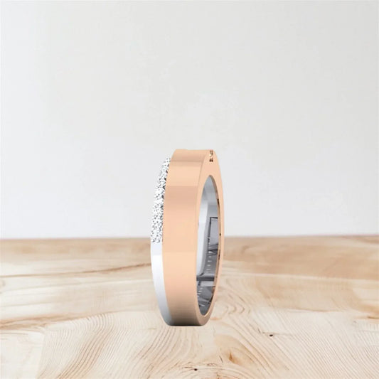 Rose gold ring with a diamond on a wooden surface