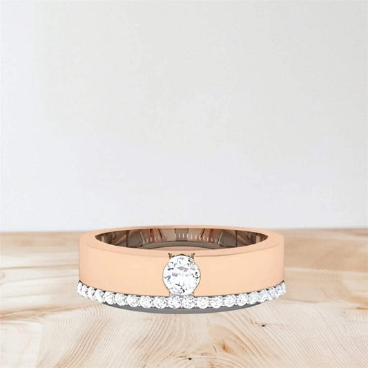 rose gold and white gold rings on a wooden surface with a light gray background.