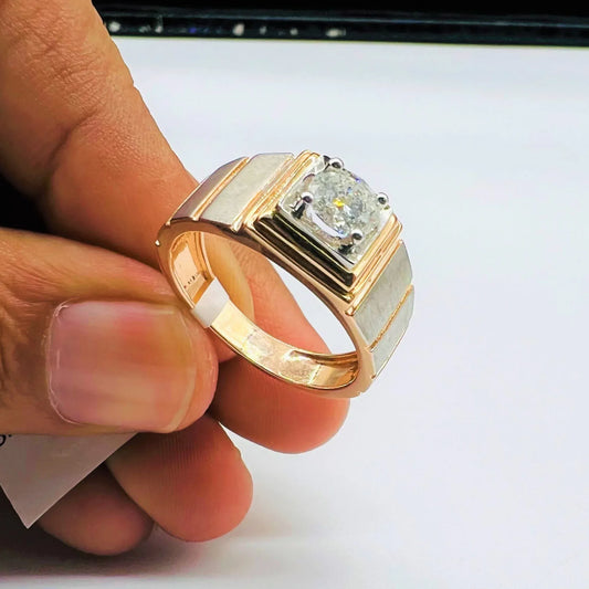 A man's hand holding a solitaire diamond ring with a gold band.