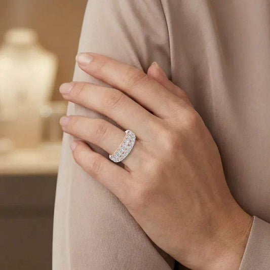 Hand wearing a lab grown diamond ring with a blurred background