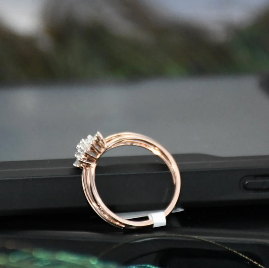 Rose gold ring with a diamond on a car dashboard