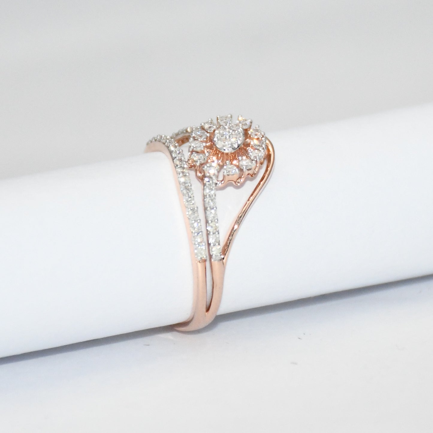 gold ring with diamonds on a white surface