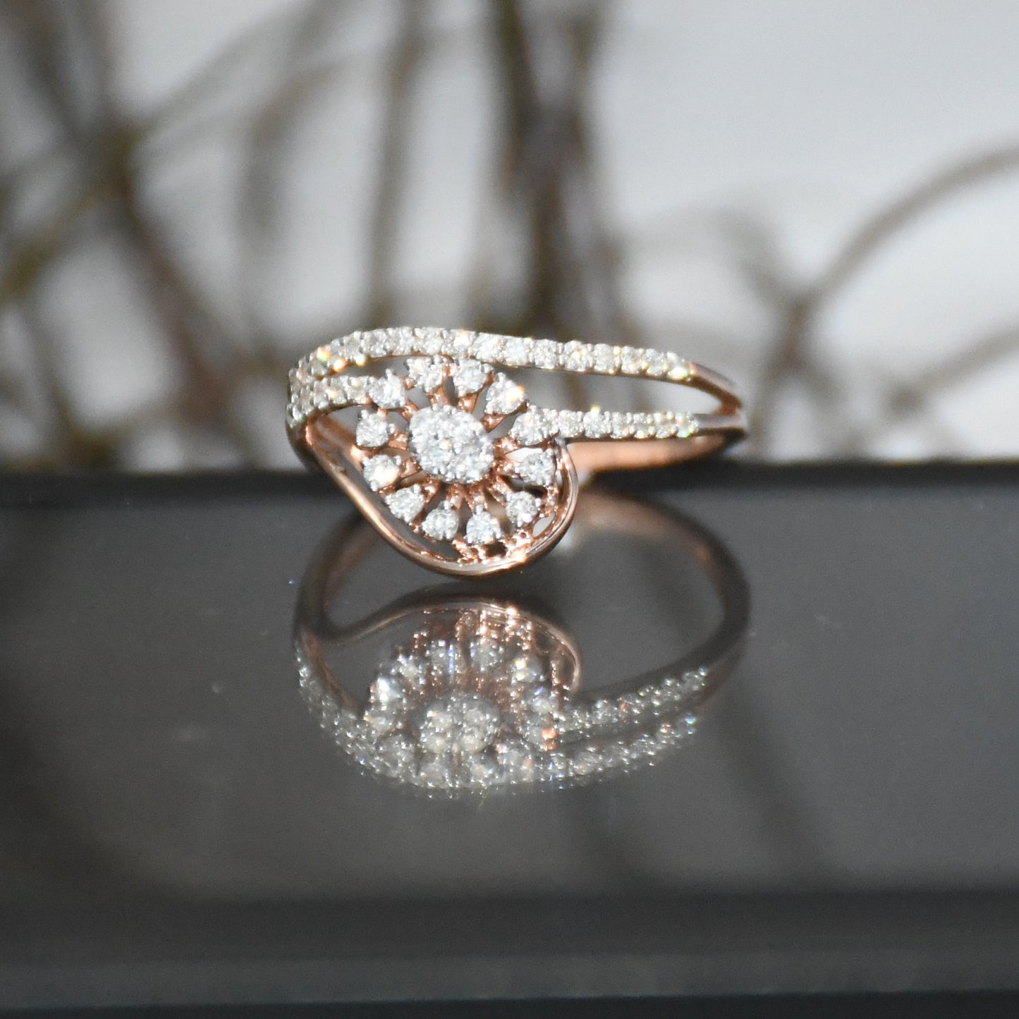 gold ring with diamonds on a reflective surface