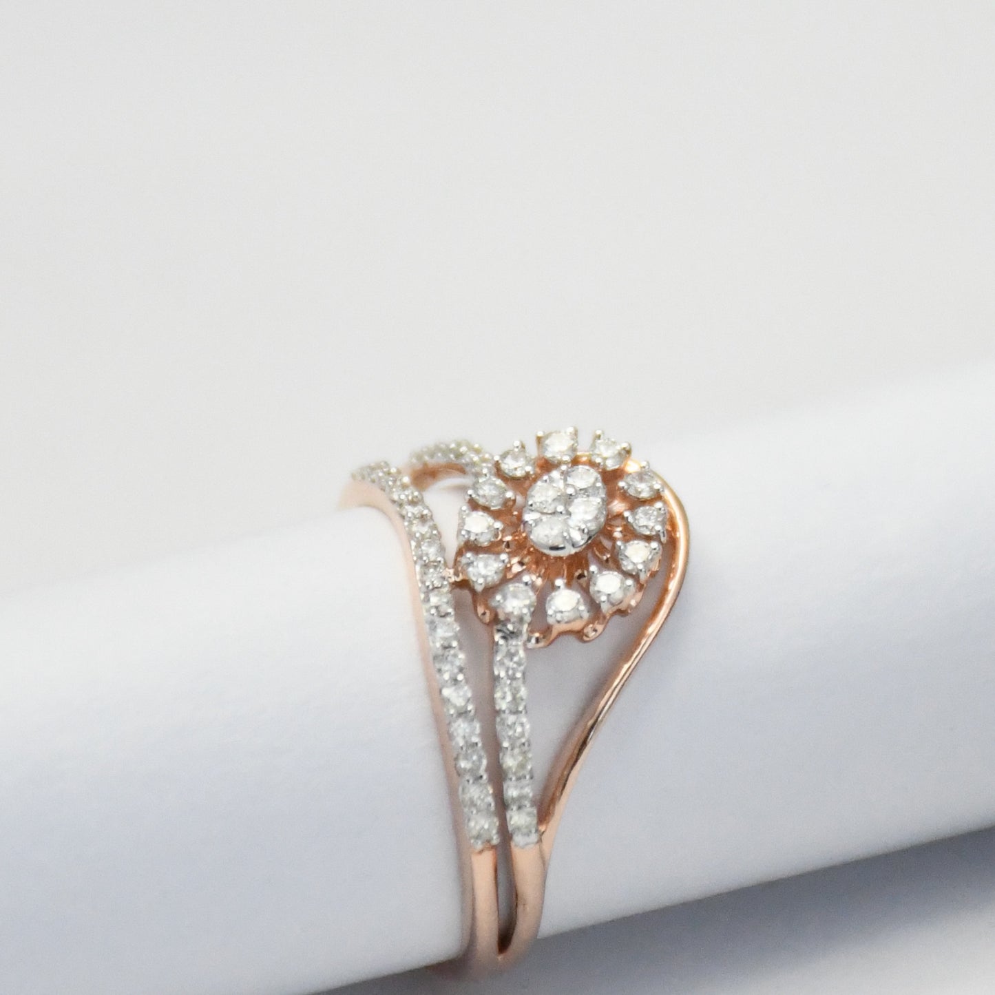 gold ring with diamond accents on a light gray background