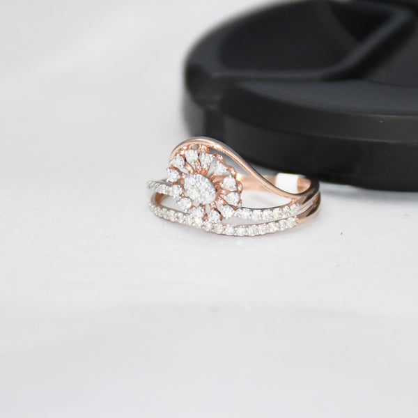 gold ring with diamond accents on a light gray surface