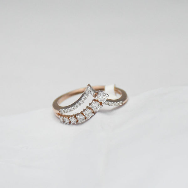 gold diamond ring on a light gray background