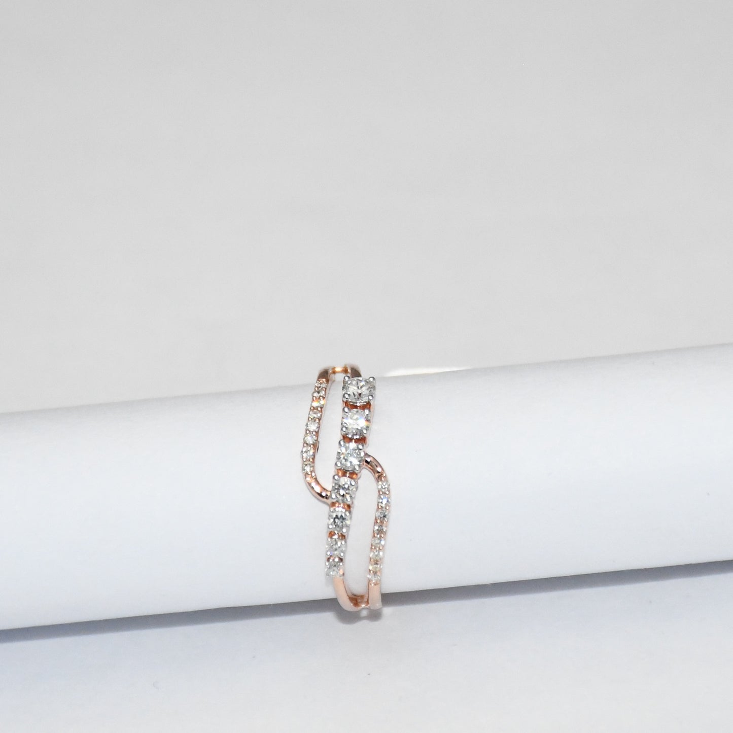 gold ring with diamonds on a white surface