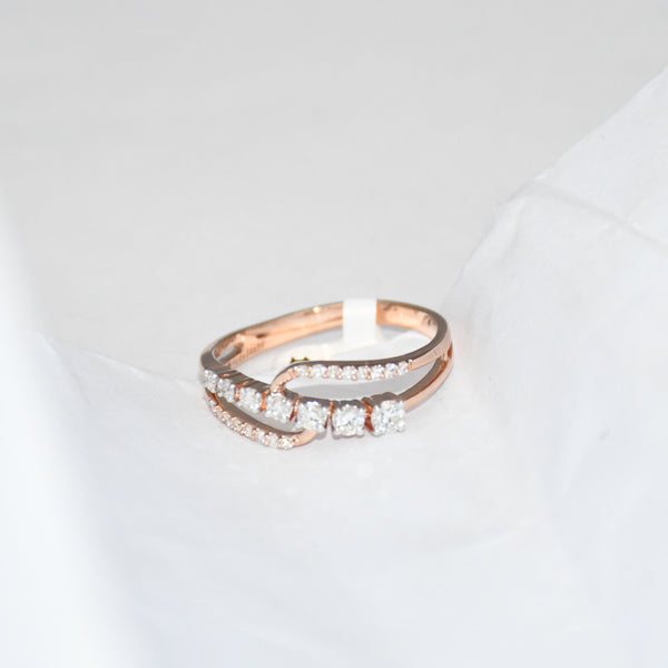 gold ring with diamonds on a light gray background