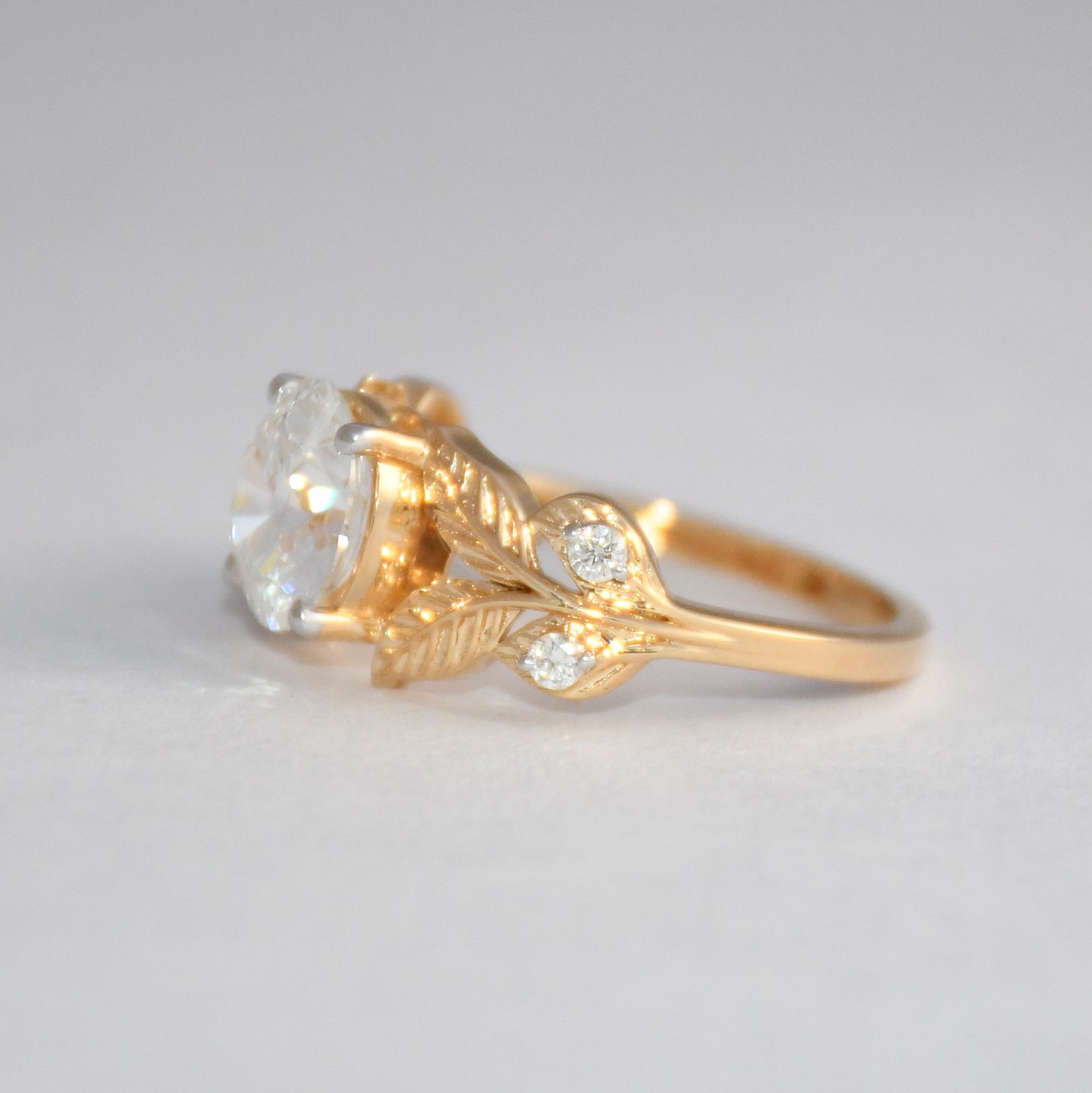 Gold ring with a diamond on a light gray background