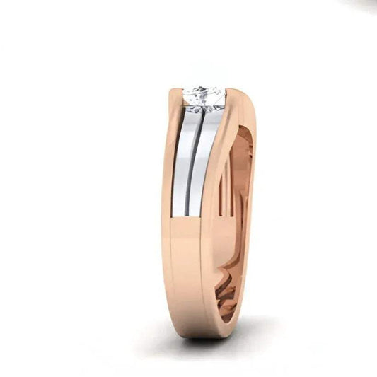 Two-tone gold ring with solitaire diamond on a white background