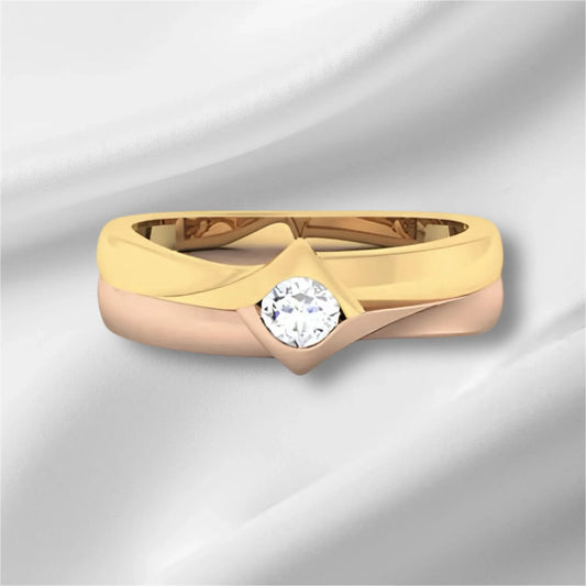 two tone gold ring with a diamond on a light gray background