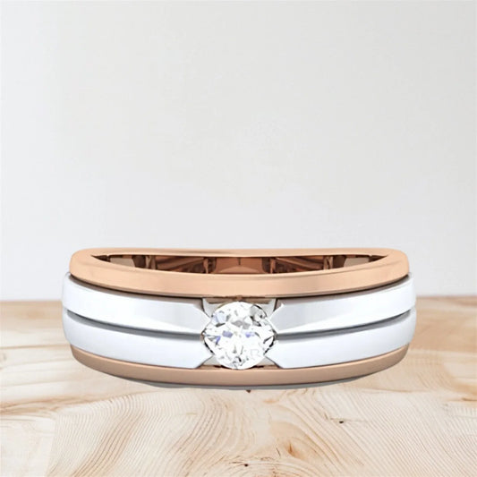 Two-tone ring with a diamond on a wooden surface