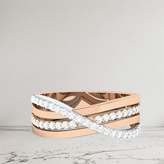 Two tone gold ring with diamond accents on a light gray background