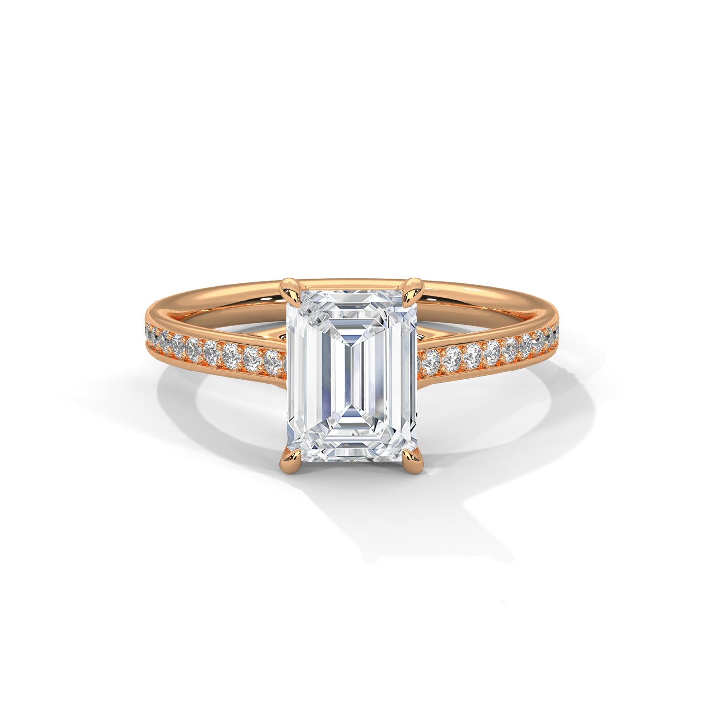 Rose gold ring with emerald-cut diamond and smaller diamonds on a white background
