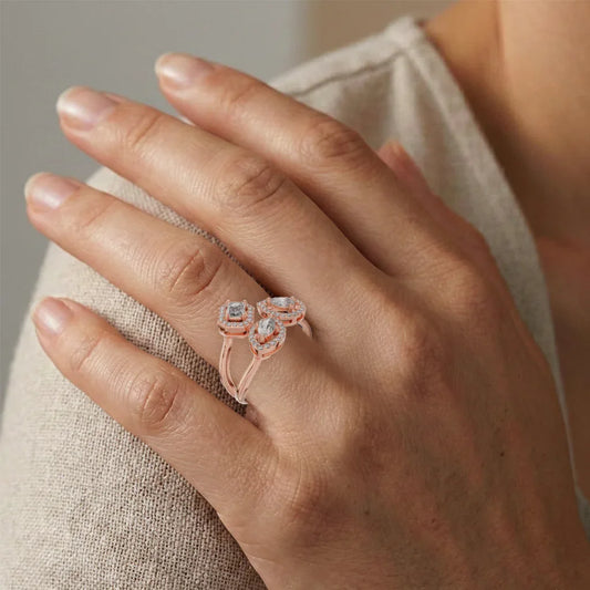 Hand wearing a rose gold ring with real diamonds on a neutral background