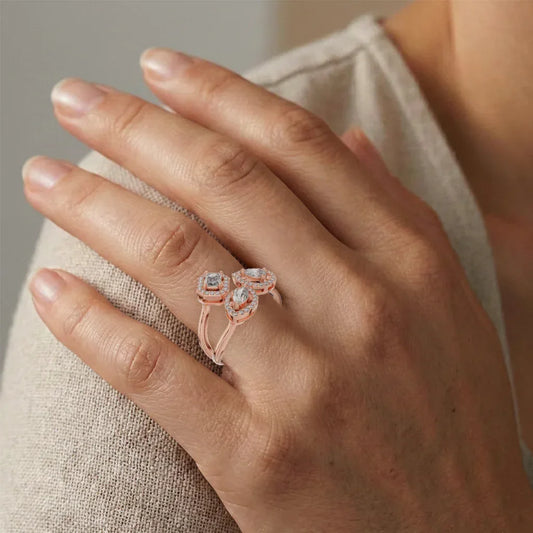Hand wearing a rose gold ring with real diamonds on a neutral background