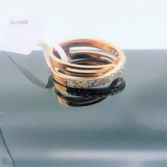 A diamond band ring with 14K gold hallmark, displayed on black reflective surface.