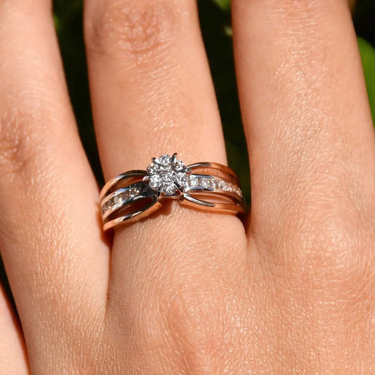 A diamond band ring with 14K gold hallmark, displayed in a hand's middle finger.